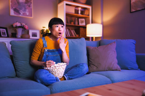 istock Woman surprised while watching TV late at night 2198143682