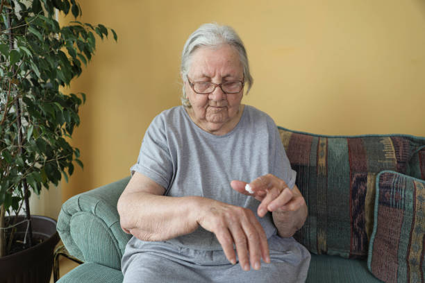 istock Hands of an Elderly Woman Applying Cream 2198146232