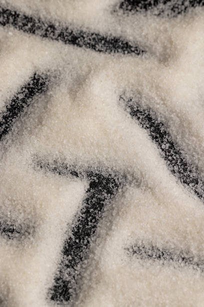 close-up of white granulated sugar on black slate