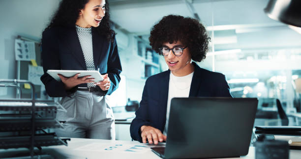 istock Office, business people and laptop for research, internet discussion and documents. Online administrator, man and corporate woman on tablet for project management, conversation and planning at desk 2198148771