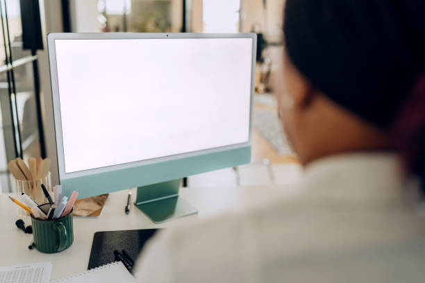 istock Female doctor using desktop PC with white blank screen at the doctor's office 2198151912