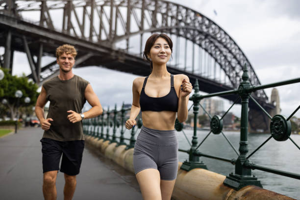 istock Two Individuals Jogging Outdoors by an Iconic Bridge 2198153413