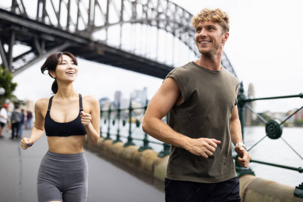 istock Active Young People Jogging in a Scenic Urban Waterfront Setting 2198153454