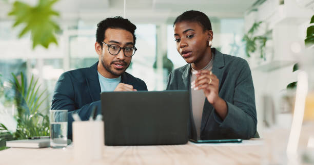 istock Office, partnership and team feedback for laptop, proposal and research notes with document for report. Man, woman and advice for business, collaboration and meeting for training or b2b project 2198155171