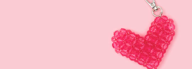Banner with pink beaded keychain in a heart shape.