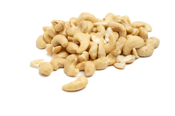 A pile of raw cashew nuts displayed on a plain white background. The simple composition emphasizes the natural texture and creamy color of the nuts.