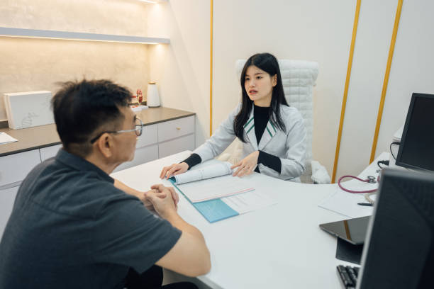 istock Consulting Care: Doctor and Patient Review Check-Up Information 2198161383