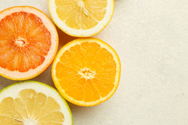 istock A close up of four oranges and a grapefruit. The oranges are cut in half and the grapefruit is cut in half as well 2198163326