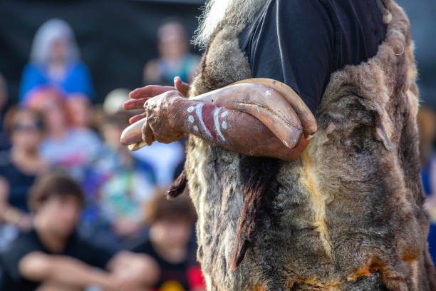 Australian aboriginal ceremony, human hand holds ritual clapsticks for the welcome rite at an indigenous reconciliation community event in Australia