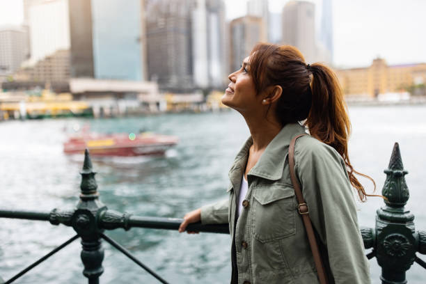 istock Young Woman Exploring a Scenic Urban Waterfront Environment 2198167577