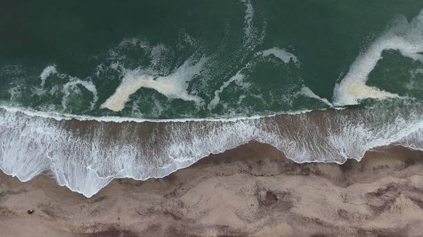 istock Clear turquoise ocean meeting sandy beach 2198170378