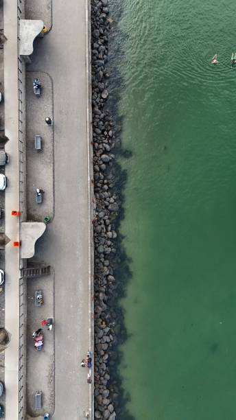 istock Coastal walkway and green sea from above 2198171827