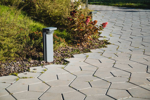 There is a charming brick walkway featuring a tall lamp post right in the center of it, providing illumination and creating a lovely atmosphere for visitors walking through the area