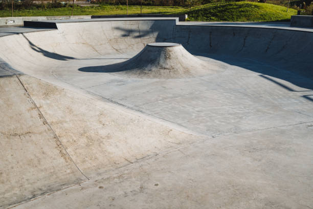 istock An expansive, empty concrete skatepark bowl showcasing a variety of unique features specifically designed for the enjoyment of skaters 2198172428