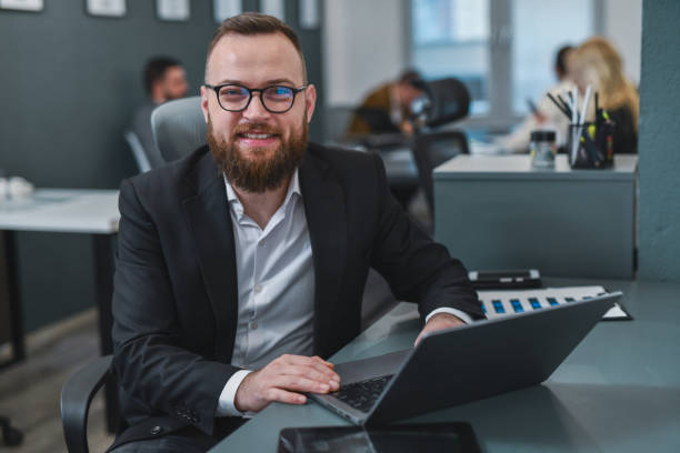 istock Handsome Male Looking Joyful Working From Office Reading Emails on Laptop 2198172780