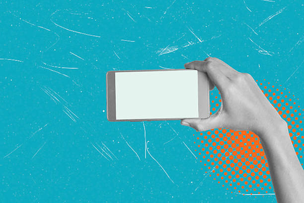 istock A woman holding a phone with a blank screen on a blue background, close-up, copy space. 2198175491