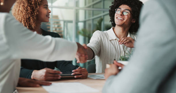 istock People, happy and handshake in office for agreement, creative collaboration and new partnership. Design team, meeting and shaking hands in agency for deal, support and project onboarding in company 2198176057