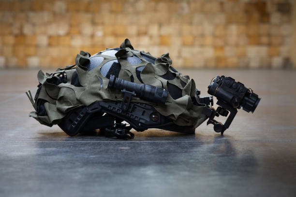 istock A tactical helmet with a thermal imaging monocular and a flashlight lies on a concrete floor. 2198179028