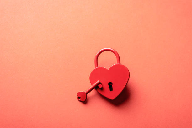 istock Red heart-shaped padlock with matching key on a bright red background, symbolizing love and security. Valentines day concept. Top view, copy space 2198180815
