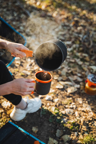 istock A person gently pours steaming, aromatic coffee into a beautifully crafted cup while comfortably relaxing in a plush armchair, savoring a delightful moment with their favorite warm drink 2198184543