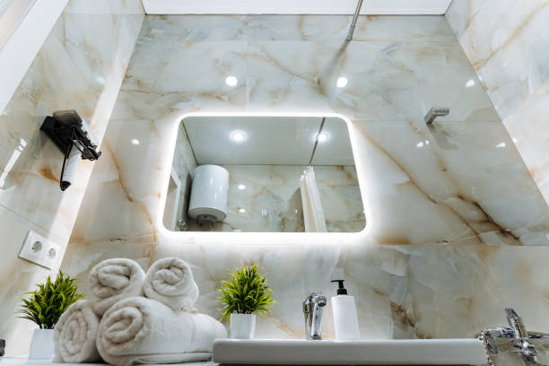 A bathroom that is equipped with a sink for washing, a mirror for reflection, and towels for drying off after use, creating a functional and comfortable space for personal hygiene activities