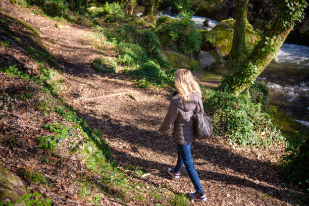 istock Woman walking in the forest 2198185237