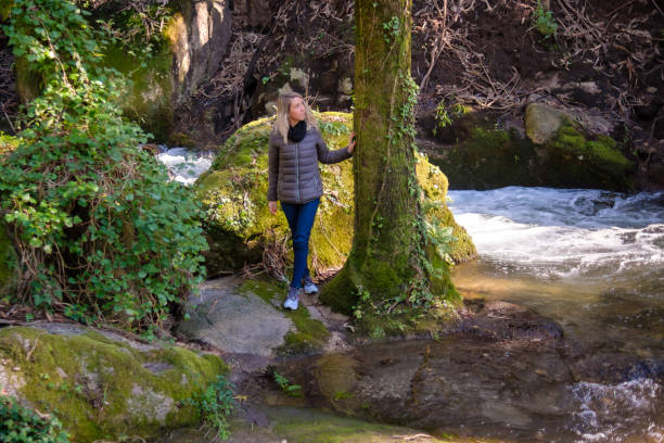 istock Woman walking in the forest 2198185311
