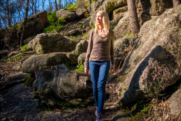 istock Woman walking in the forest 2198185353