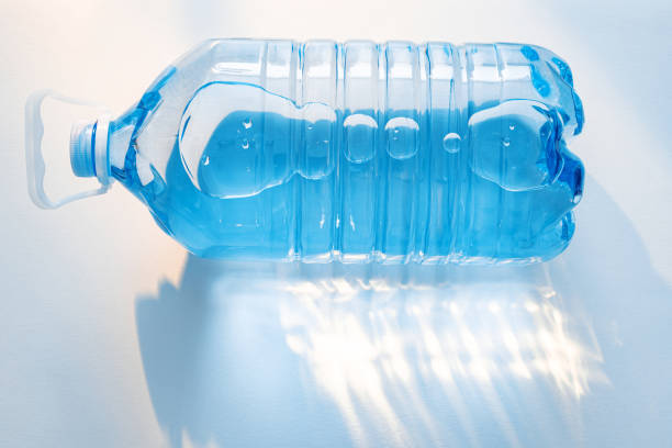 istock Bright sunlight illuminates a clear water bottle on a surface showcasing reflections and shapes 2198187272