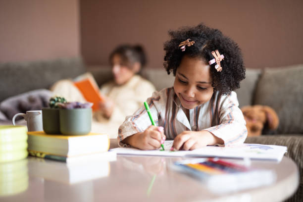 istock Cute mixed - race girl drawing at home. 2198187672