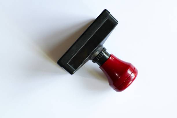 istock Close-up shot of black and red office stamp on a pristine white surface 2198189125