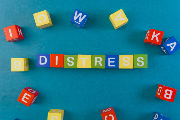 Colorful building blocks arranged to form the word distress on a vibrant blue background, highlighting emotions.