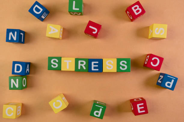 istock Colorful blocks spell stress on an orange background 2198189939