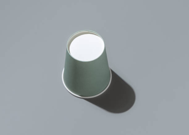 istock Disposable light green paper cup on a grey with hard shadow top view , mockup. Sustainable lifestyle 2198189955