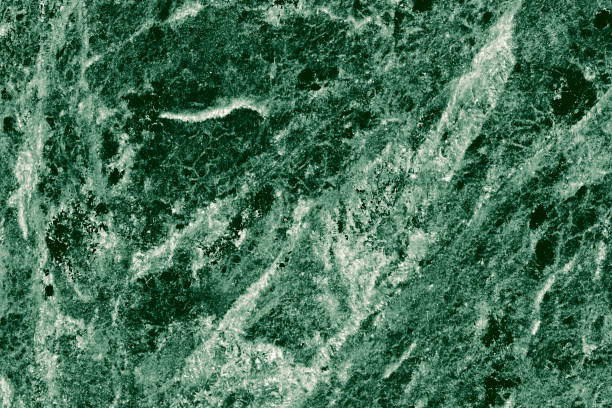 istock Real closeup of dark green marble stone texture surface background. Design pattern with high resolution for luxury home decoration. Abstract matt slab rock material. Front view of natural tiles stone surface. 2198190618