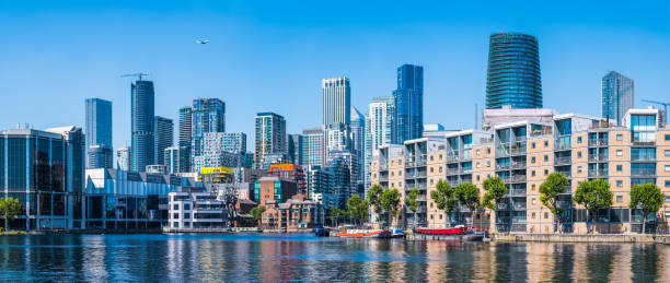 istock Waterfront apartment buildings below modern skyscraper skyline panorama Docklands London 2198191426