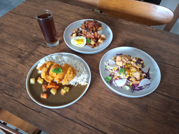 istock Chicken Curry Rice With Chicken Meat, Rice, Carrot Diced, Diced Cube Potatoes And Savory Curry Sauce. Kaarage Chicken Salad With Fresh Vegetables. Locomoco Loco Moco With Hawaiian Beef Patty, Sunny Side Up Eggs And Rice. Fresh Tea Iced.  Food And Drink. 2198193302
