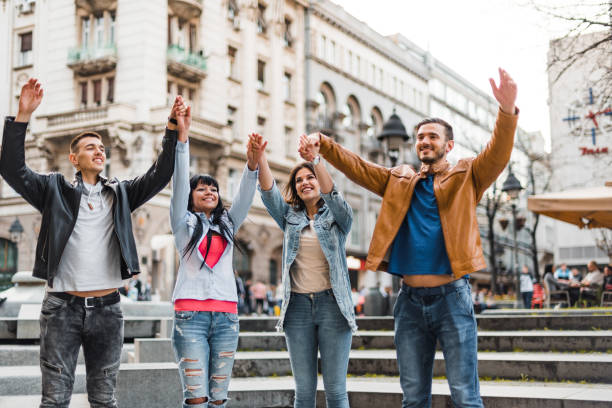 istock happiness friends holding hands on the city 2198193600