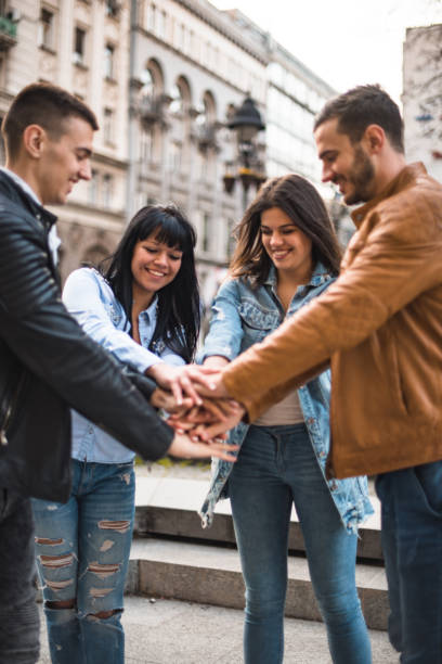 istock happiness friends holding hands on the city 2198193876