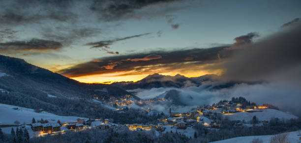 istock Snowy mountain village at sunset 2198193925