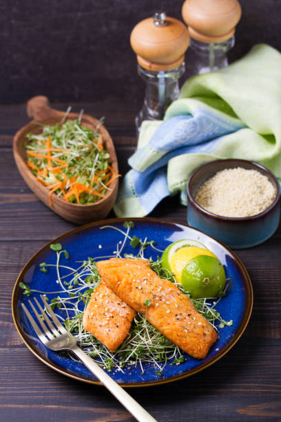 istock Grilled salmon fillet with microgreens on blue plate. 2198194686