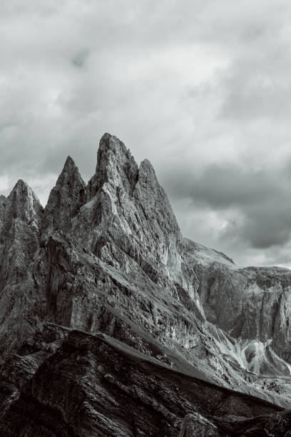 istock Seceda peaks in the Dolomites, Italy, are captured in a monochrome vertical format. Sharp textures and the interplay of light and shadow emphasize the rugged alpine terrain 2198196864