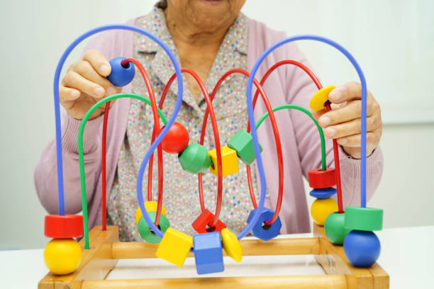 istock Asian elderly woman playing enhancing skill board game. 2198196961