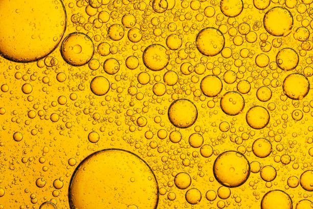 istock Macro close up of yellow bubble texture,Macro microscope yellow bubble texture, Close-up Yellow bubbles and drops oil background . golden Yellow water bubbles, close up golden oil drop for celebration 2198197165