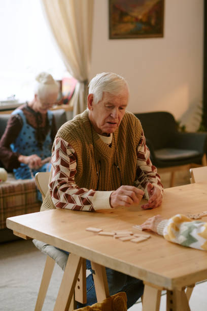 istock Elderly Man Playing Domino with Companion 2198197813