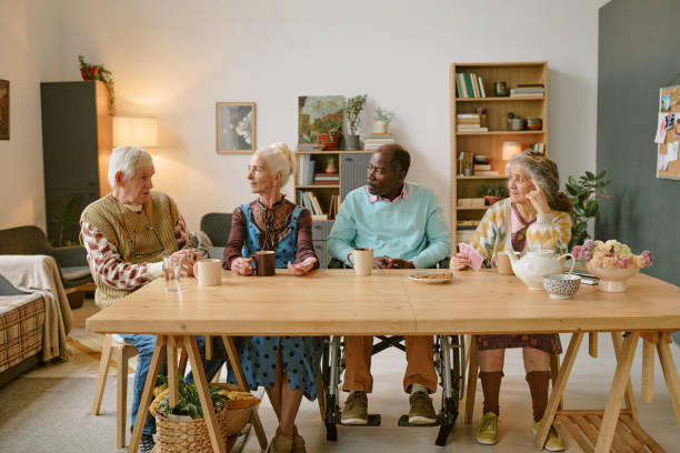 istock Residents of Nursing Home Chatting at table 2198198080
