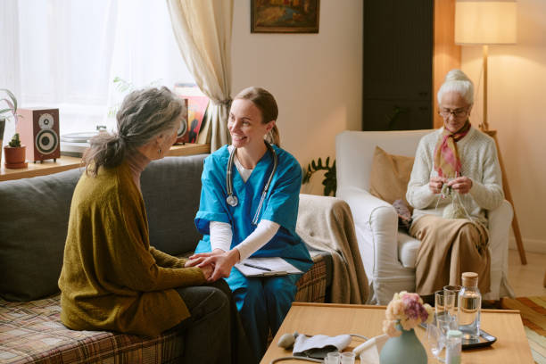 istock Nurse Supporting Elderly Woman 2198198392