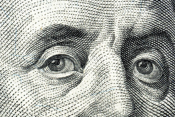 istock Close-up of engraved eyes from a dollar bill design. 2198199334