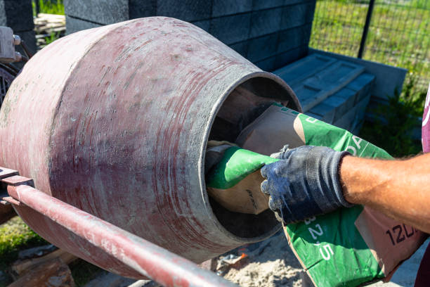 istock Mixing different ingredients for concrete in a portable concrete mixer. 2198200590