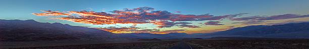 istock Scenic desert road at sunset with colorful clouds and mountain backdrop 2198202701